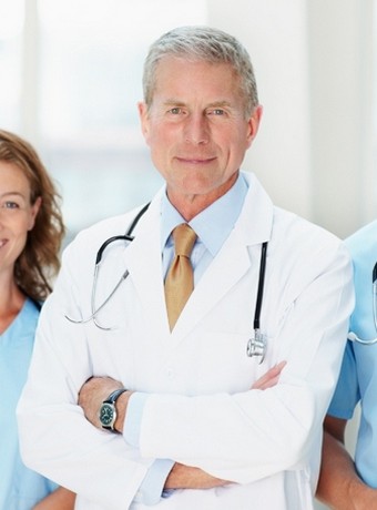 Group of doctors smiling against blur background